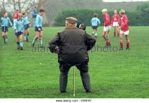 man-sitting-on-a-traditional-shooting-stick-seat-watching-sport-c95f8y.jpg